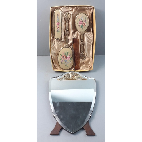 596 - A shield shaped mirror 36cm tall along with a very attractive dressing table set.  Attractive and cl... 