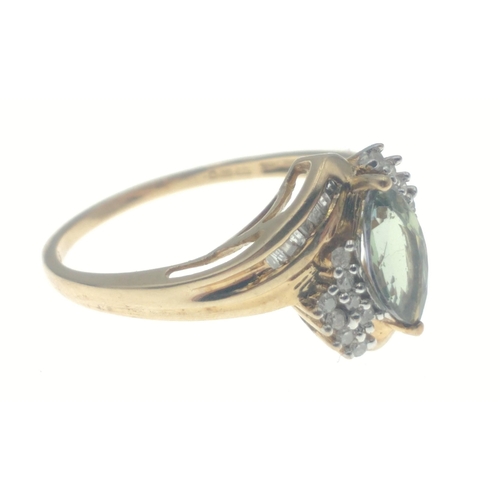 6 - A 9ct hallmarked ring set with an oval green stone surrounded by 2 rows of diamond chips (tested but... 