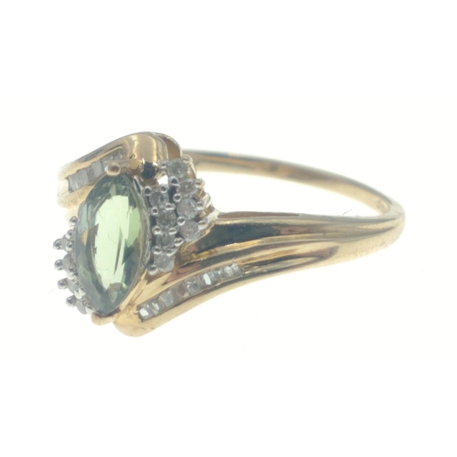 6 - A 9ct hallmarked ring set with an oval green stone surrounded by 2 rows of diamond chips (tested but... 