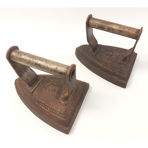 405 - A pair of antique 7 flat irons with wear but complete in good order. Each 15cm.#59