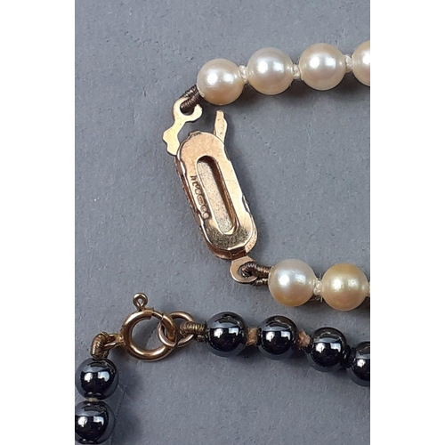 5 - A box containing 2 sets of quality pearls, the black strand with faint 9k mark to clasp, the other s... 