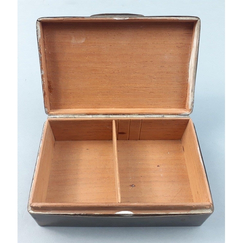 55 - A sterling silver hallmarked cigarette case with rubbed marks and damaged hinges.  Cedar wood lined ... 