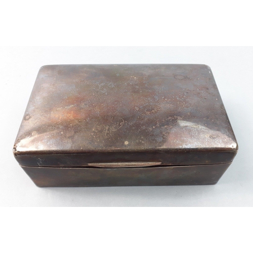 55 - A sterling silver hallmarked cigarette case with rubbed marks and damaged hinges.  Cedar wood lined ... 