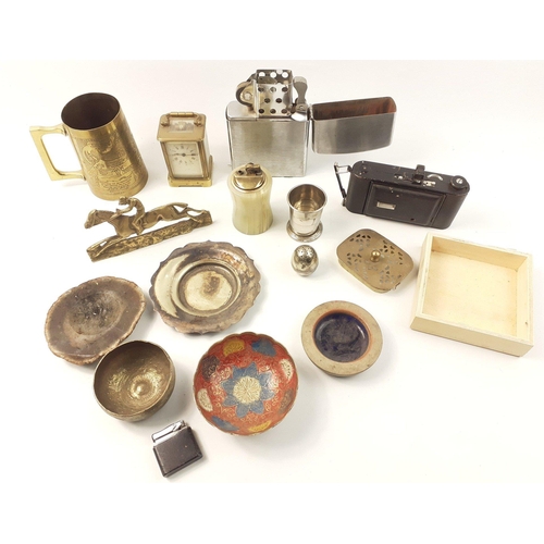 588 - A mixed lot to include an oversize Zippo style lighter, a folding camera, a brass tankard, a small b... 