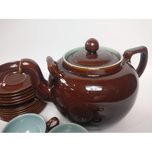 284 - A retro DENBY part set in a highly glazed brown finish with blue inners to include a super size teap... 