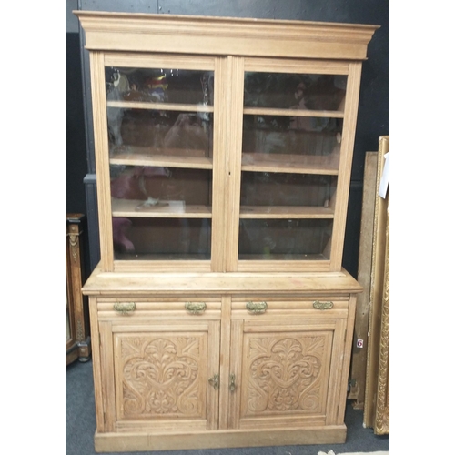 386 - An imposing natural wood dresser with glazed upper with 3 shelves, 2 drawers and a 2 door carved bot... 