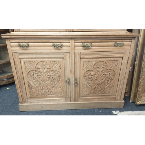 386 - An imposing natural wood dresser with glazed upper with 3 shelves, 2 drawers and a 2 door carved bot... 