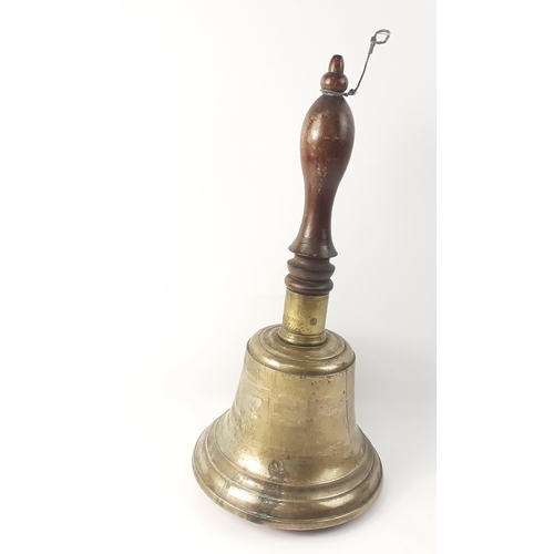 154 - An impressive hand bell with wooden handle, with an equally impressive ring sound.  Height 42cm#24... 