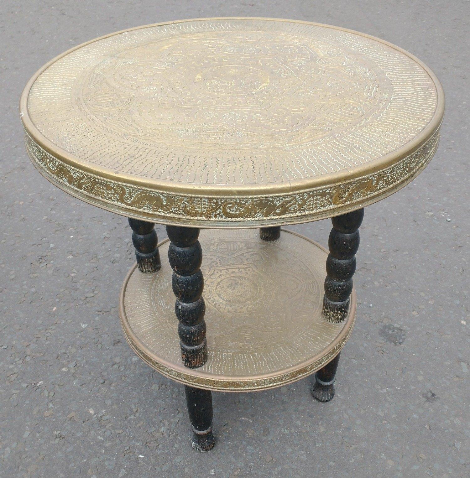 An unusual antique Chinese 2 tiered brass-topped table supported on 4 ...