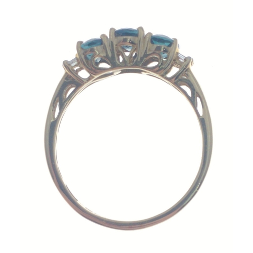 10 - A gold ring stamped 14K with 3 central blue stones with 4 rectangular diamonds to each side, size P,... 