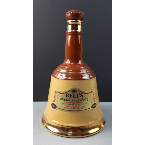 155 - An empty WADE ceramic Bell's Scotch Whisky decanter standing 25cm tall.  In good order#156