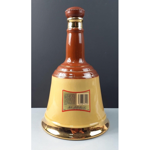 155 - An empty WADE ceramic Bell's Scotch Whisky decanter standing 25cm tall.  In good order#156