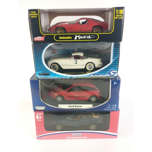 163 - Four 1:18 scale MAISTO diecast models to include a Kid Cast RANGE ROVER, MotorMax FORD FOCUS, Anson ... 