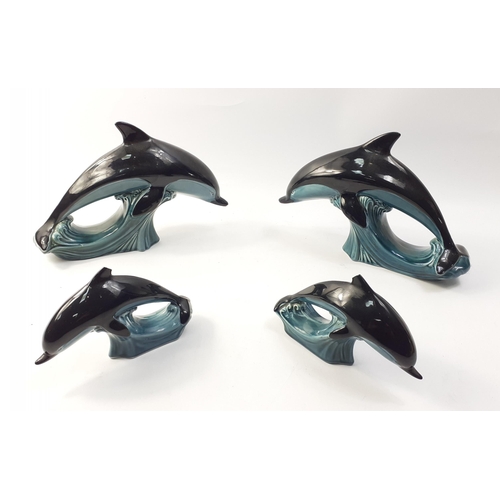 215 - Four leaping dolphins by BLUE MOUNTAIN to include 2 x 19cm and 2 x 12cm (smaller pieces both have da... 