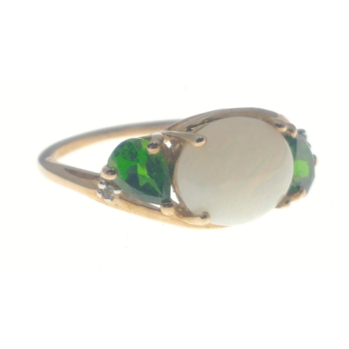 22 - A TGGC 9K hallmarked ring with an oval opal centre stone (10mm approx) and 2 teardrop shaped emerald... 