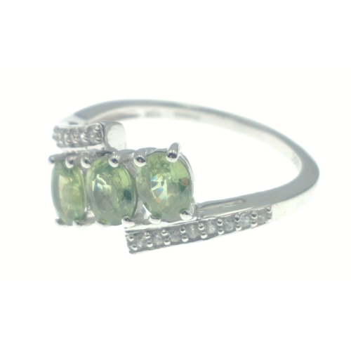 41 - 10k stamped (9ct hallmarked) white gold ring set with three green stones and white stones on shoulde... 