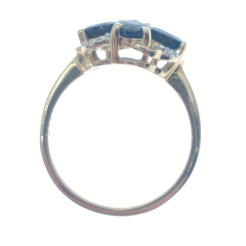44 - 10k stamped (9ct hallmarked) yellow gold ring set with 4 oval cut blue stones in flower head design ... 