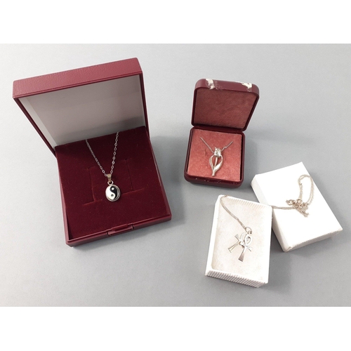 75 - A small silver jewellery collection to include a tulip style pendant, a Yin & Yang pendant on a ... 