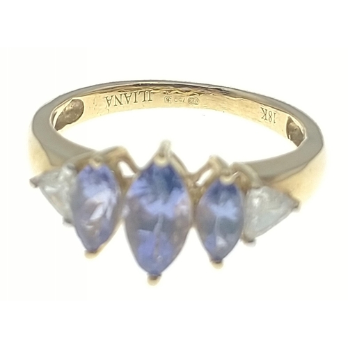 8 - A gold ring stamped Iliana and marked 18K with a trio of attractive navette cut purply blue stones w... 