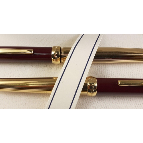 104C - Two TED LAPIDUS of Paris ballpoint pens in TED LAPIDUS white presentation case. Both in similar desi... 