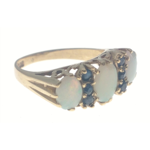 7J - A SUBSTANTIAL 375 stamped OPAL ring with three attractive stones and six small sapphires. The middle... 