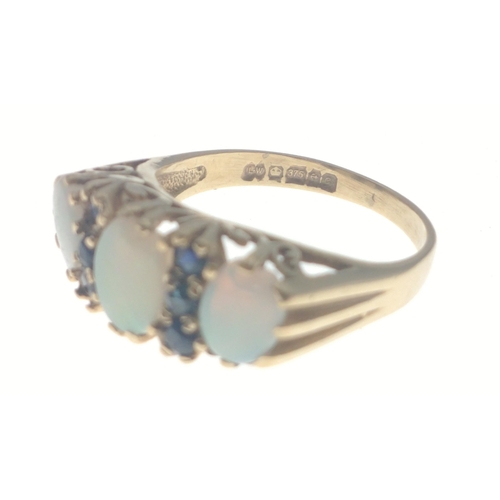 7J - A SUBSTANTIAL 375 stamped OPAL ring with three attractive stones and six small sapphires. The middle... 