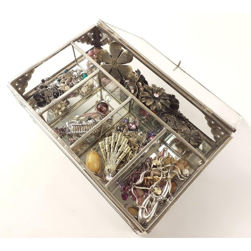 82 - A glass jewellery box with white metal corners to include contents of costume jewellery.  Some very ... 