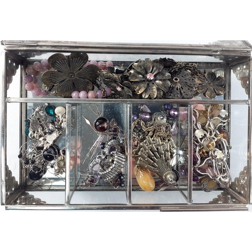 82 - A glass jewellery box with white metal corners to include contents of costume jewellery.  Some very ... 