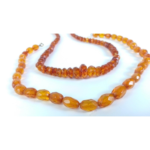 86 - A graduated amber beaded necklace with screw fitting 43cm long approx, weighs 16g approx and one oth... 