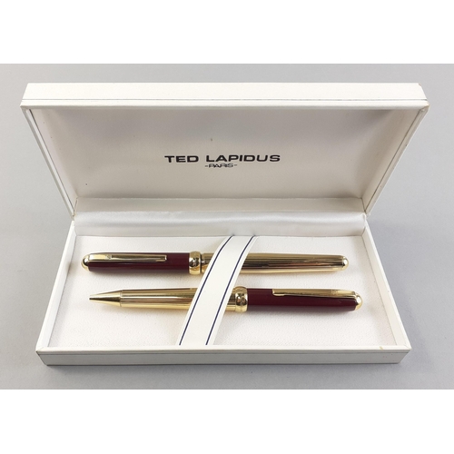 104C - Two TED LAPIDUS of Paris ballpoint pens in TED LAPIDUS white presentation case. Both in similar desi... 