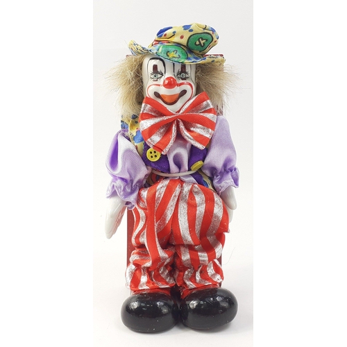 240 - A ceramic faced boxed clown, 15cm approx#56