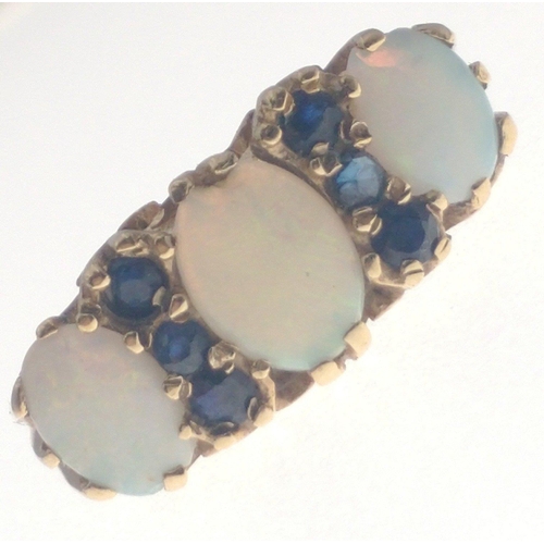 7J - A SUBSTANTIAL 375 stamped OPAL ring with three attractive stones and six small sapphires. The middle... 