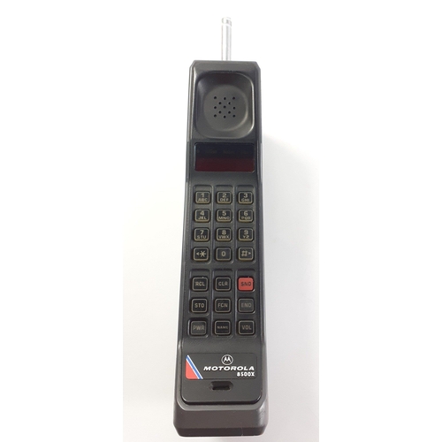 288 - A vintage MOTOROLA 8500X mobile phone with charger, base and books. Aerial broken#301