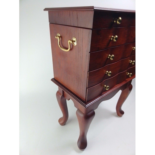 110 - A modern 3 drawer bijouterie cabinet on four leg supports with folding top, and double brass handles... 