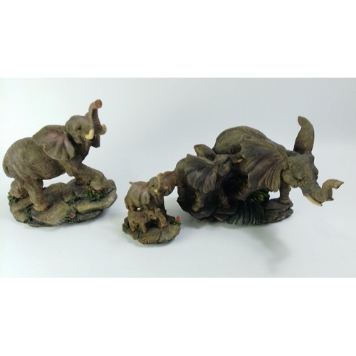 223 - Three realistic looking elephant figurines, largest group H18 x L30cm approx. No damage.#60