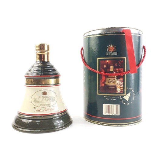 166 - A BELL'S 1989 Christmas bell decanter with 75cl contents of blended Scotch whisky.  Comes with origi... 