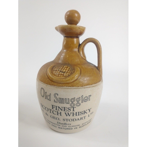 3 - A vintage OLD SMUGGLER flagon (22cm high), a CHEQUERS whisky flagon (22cm high) and a German made ba... 