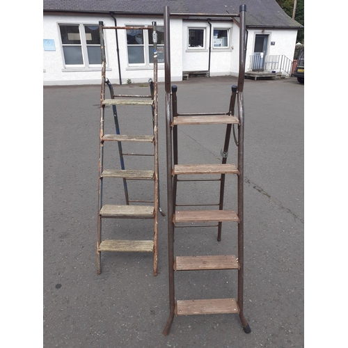 Two metal tube frame folding ladders with 5 wooden steps#489