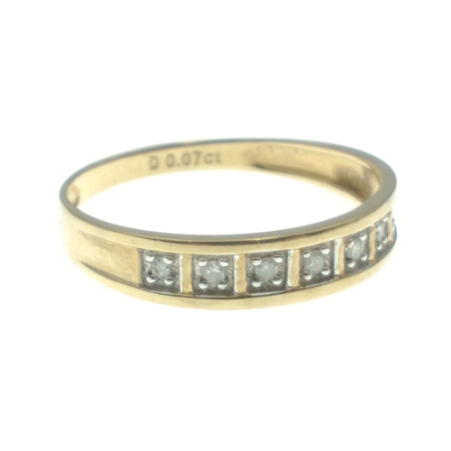 11 - A lovely yellow metal band with diamonds stamped 0.07ct. All seven diamonds present. Gross weight 1.... 