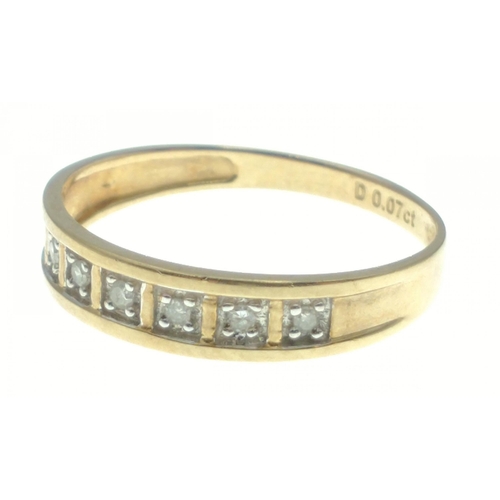 11 - A lovely yellow metal band with diamonds stamped 0.07ct. All seven diamonds present. Gross weight 1.... 