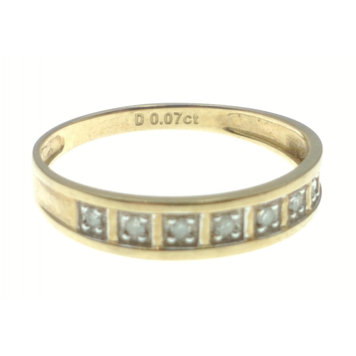 11 - A lovely yellow metal band with diamonds stamped 0.07ct. All seven diamonds present. Gross weight 1.... 