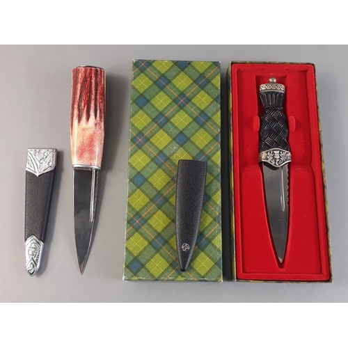 180 - Two Scottish Sgian-dubh.  One boxed 18cm dirk in presentation box and a coloured handle one 21cm. Ni... 