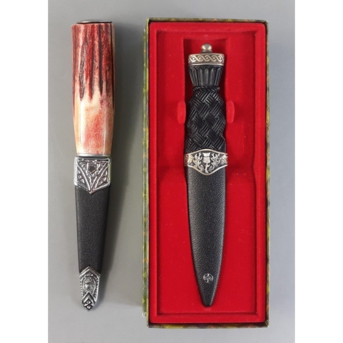 180 - Two Scottish Sgian-dubh.  One boxed 18cm dirk in presentation box and a coloured handle one 21cm. Ni... 