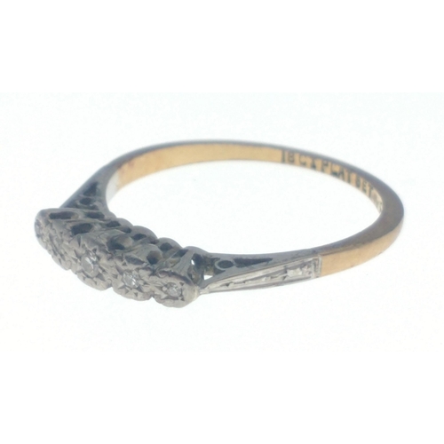 23 - A ring stamped 18ct Plat Set F8100 with five small inset diamonds. Size O, gross weight 2.25g approx... 