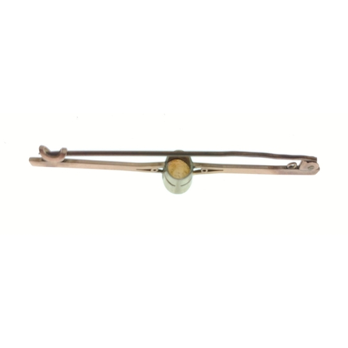 32 - An attractive bar brooch, set with an opal, in unmarked yellow metal (non-reactive to a magnet) but ... 