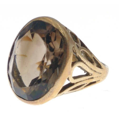 39 - A large chunky 9ct stamped gold ring set with Cairngorm style stone, with pierced shoulders, size N,... 