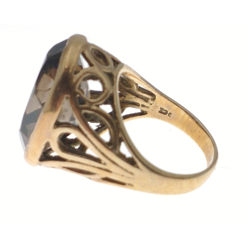 39 - A large chunky 9ct stamped gold ring set with Cairngorm style stone, with pierced shoulders, size N,... 