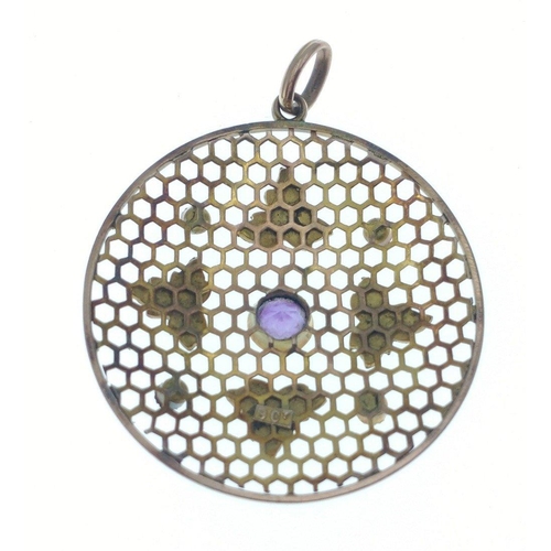 42 - A very pretty 9ct stamped pendant with small amethyst coloured stones and seed pearls.  30mm diamete... 