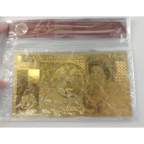 86 - A quantity of nicely produced gold banknotes in sealed packs. In excellent condition.#85