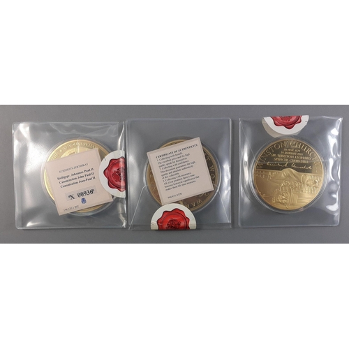 89 - Three large commemorative gold plated 70mm coins in holders with certificates. In a handy wooden box... 